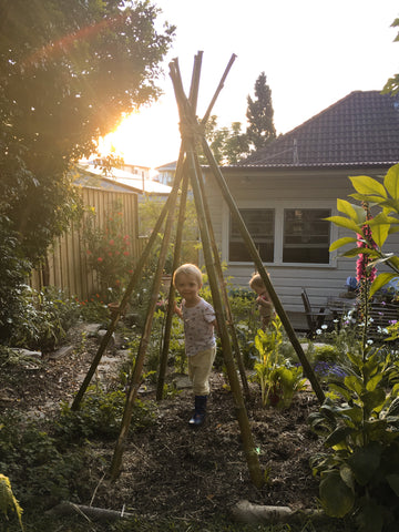 My kids in our backyard flower garden